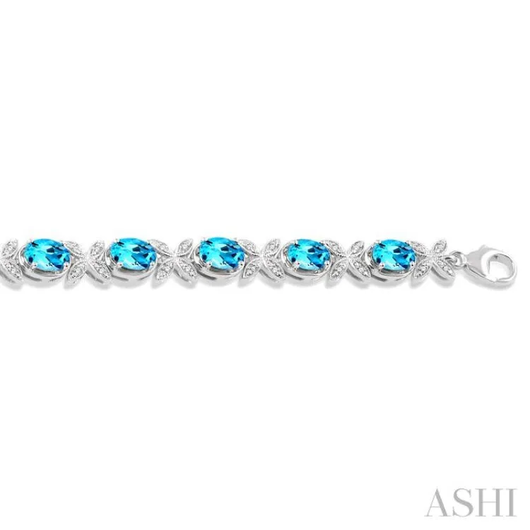 1/10 Ctw Round Cut Diamond & 7x5MM Oval Cut Blue Topaz Semi Precious Bracelet in Sterling Silver